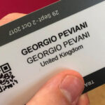 The author holding a Georgio Peviani business card.