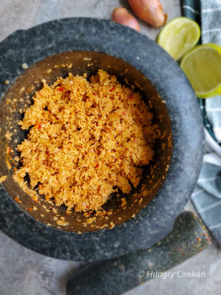 Bowl of Sri Lankan Coconut Sambol, a vibrant and flavorful dish, embodying sambal shree fashion in culinary arts.