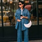 alt text: Woman wearing a denim jacket and jeans, showcasing the double denim trend popular in the 90s and 2000s.