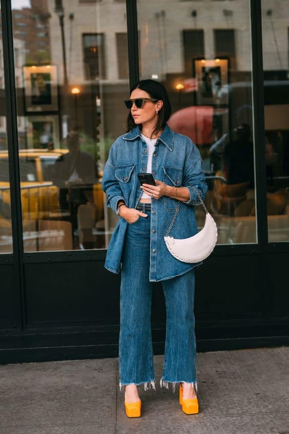 alt text: Woman wearing a denim jacket and jeans, showcasing the double denim trend popular in the 90s and 2000s.