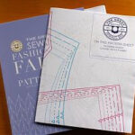 Alt: Close up of sewing pattern sheets from the Great British Sewing Bee book showcasing clear organization and labeling.