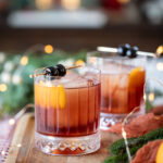 dolomite old fashioned cocktails served in glasses with festive decor.