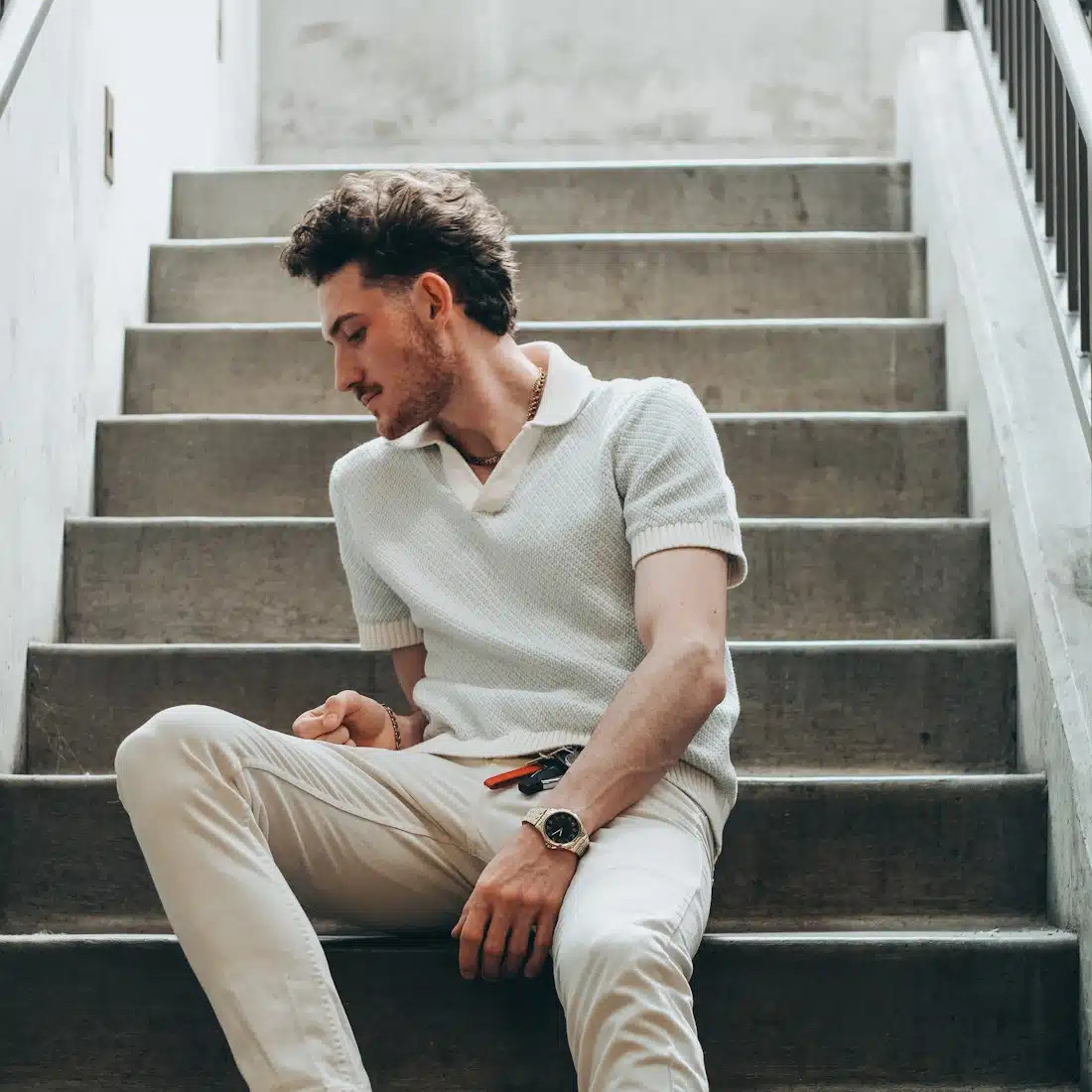 A man wearing a well-fitted navy blue polo shirt and khaki chinos, demonstrating ideal slim-fit clothing for skinny men, enhancing physique without appearing baggy.