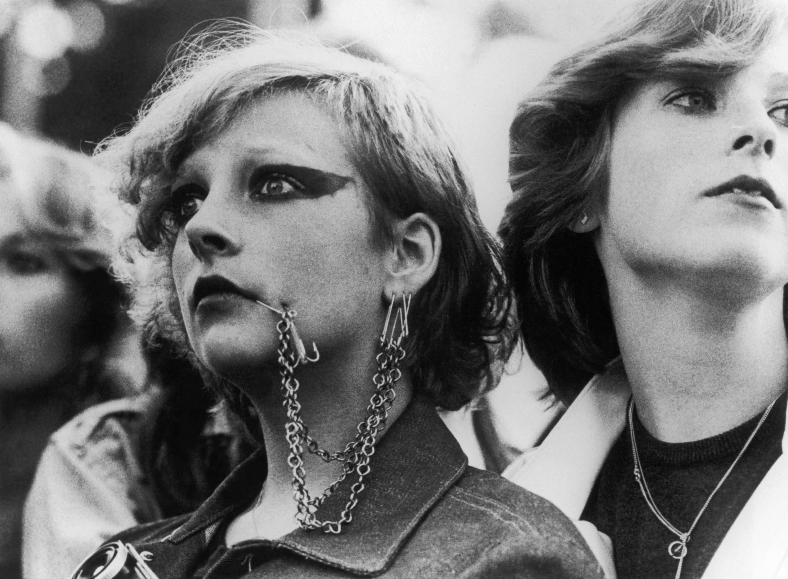 Facial piercings and studded leather jacket, iconic elements of 1970s punk fashion, showcasing rebellious youth culture