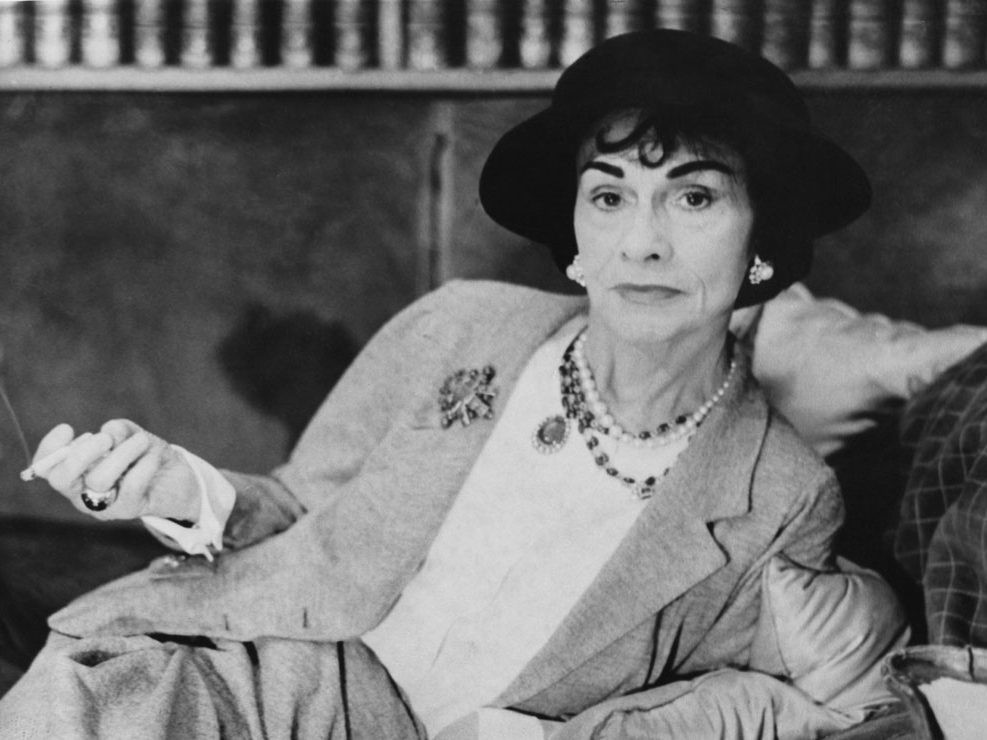 Coco Chanel, a legendary figure in the world of fashion design, photographed in 1962, epitomizing timeless elegance and innovation.