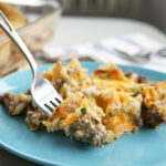 alt text: A close-up image of a vegetarian green chili casserole, showcasing the layers of corn tortillas, melted cheese, and visible green chilies.