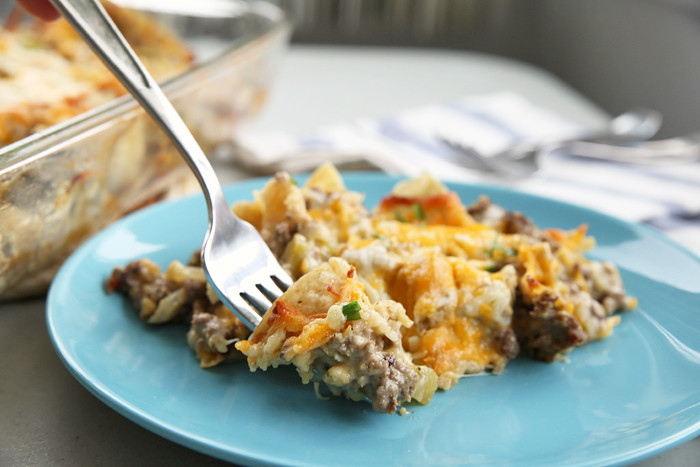 alt text: A close-up image of a vegetarian green chili casserole, showcasing the layers of corn tortillas, melted cheese, and visible green chilies.