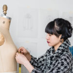 A person measures a dressmaker