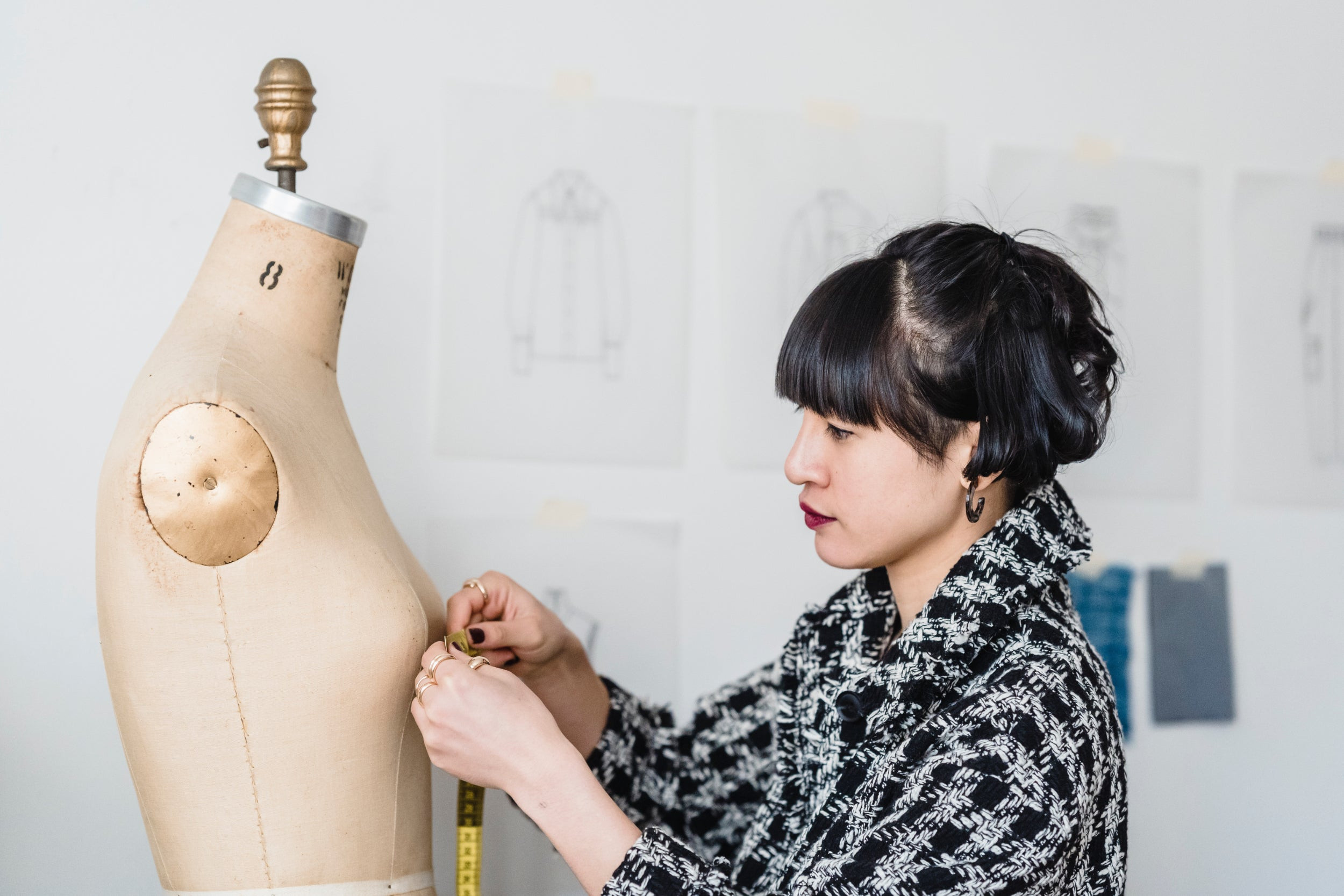 A person measures a dressmaker