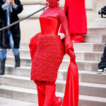 Doja Cat at Schiaparelli's Spring 2023 couture show covered in red crystals.