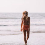 Woman wearing a stylish swimsuit on a Goa beach.