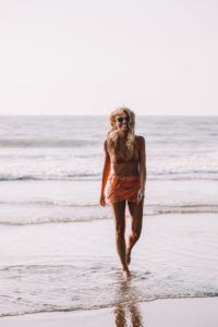 Woman wearing a stylish swimsuit on a Goa beach.