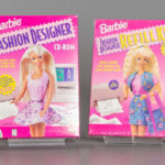 alt text: A young girl playing Barbie Fashion Designer on a computer, focused on creating a new outfit for her doll.