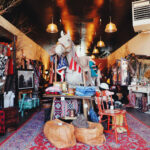 Interior of The Shop Outpost with vintage clothing and decor.