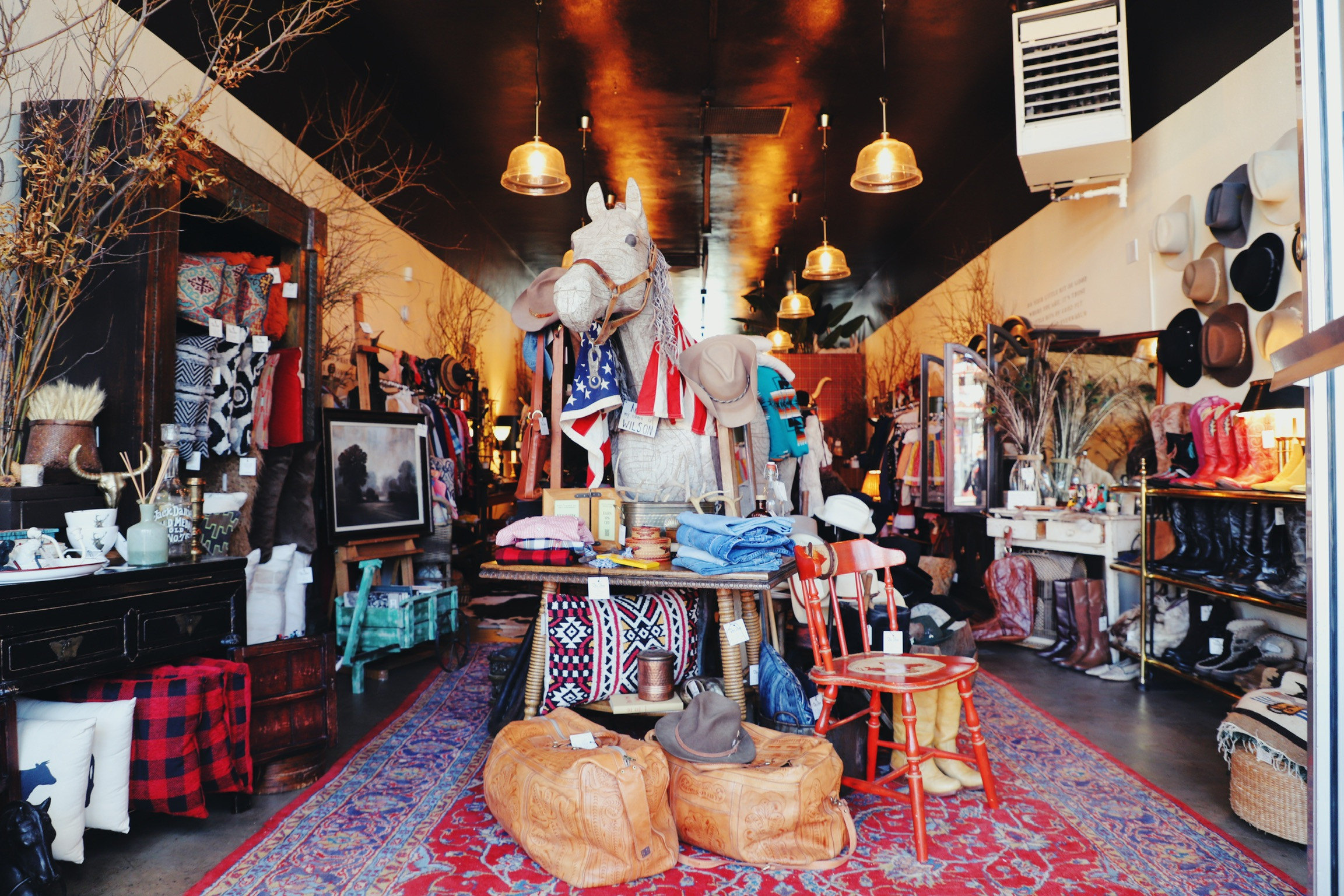 Interior of The Shop Outpost with vintage clothing and decor.