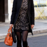 Pippa Middleton in a black dress, coat, and brown leather fashion boots.