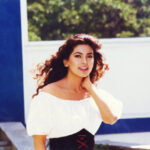 Juhi Chawla in a charming off-shoulder top from the Bollywood movie Darr, showcasing 90s fashion trends and elegant style.