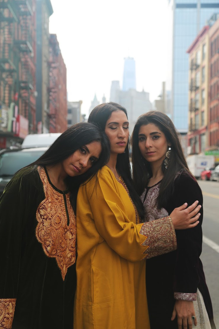 Three models showcasing traditional Kashmiri Pherans with intricate Tilla embroidery in New York City, highlighting the elegance of Kashmiri craftsmanship and Kashmiri fashion in an urban setting.