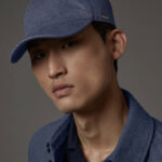 Man wearing a Loro Piana cashmere baseball cap and a sophisticated streetwear outfit, showcasing luxury fabrics in mens streetwear fashion.