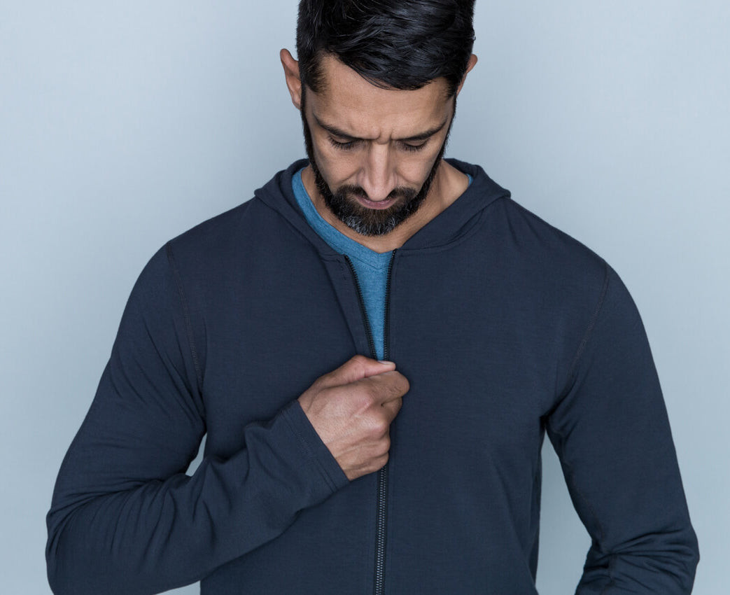 Tall man in blue hoodie layering for style and warmth.