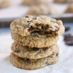 Oatmeal chocolate chip cookies on a white napkin.