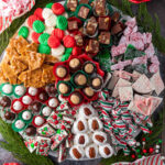 A festive Christmas candy board filled with various homemade treats.