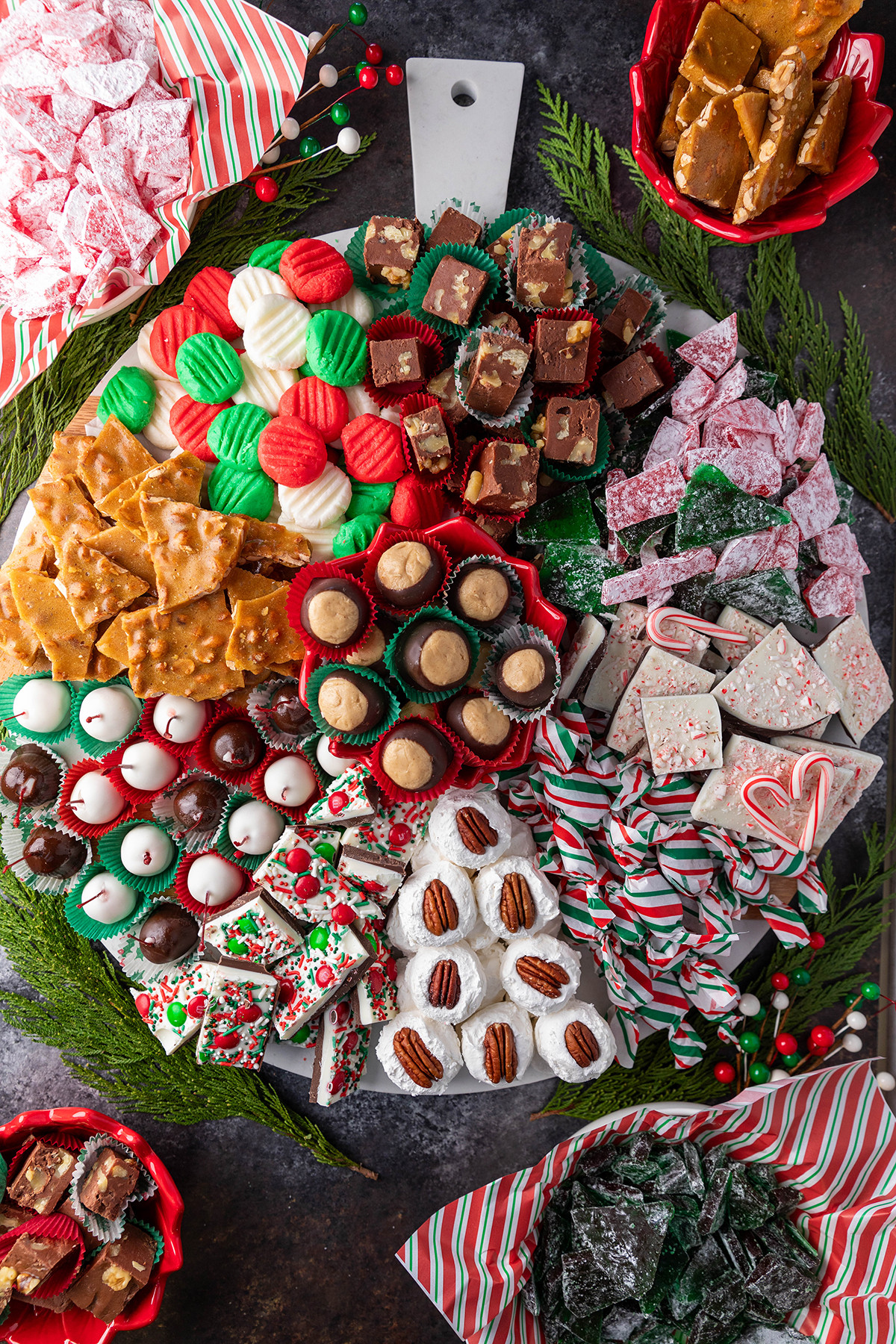 A festive Christmas candy board filled with various homemade treats.