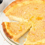 whole old-fashioned custard pie with a slice cut