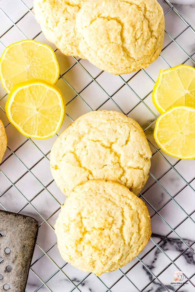 Lemon Cookies on a wire rack with slices of lemon