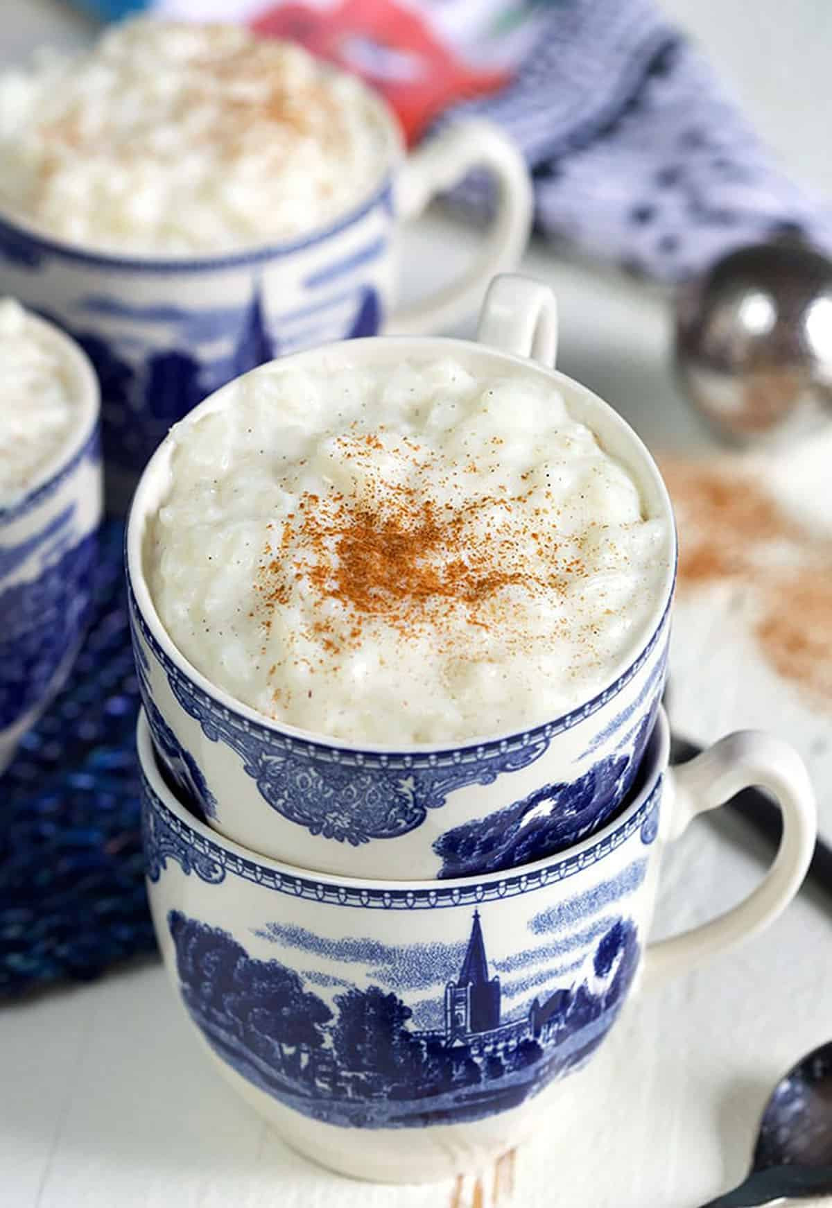 Classic rice pudding served in stacked blue and white teacups.