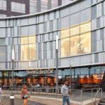 Exterior view of Fashion Centre at Pentagon City, showcasing its modern architecture and inviting entrance, perfect for shopping in Arlington VA.