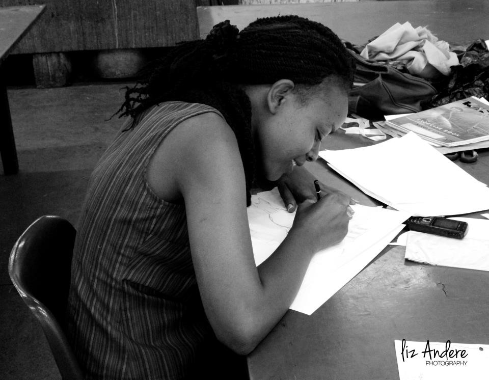 Irene Muthami sketching fashion designs, showcasing her formative stage and skill development.