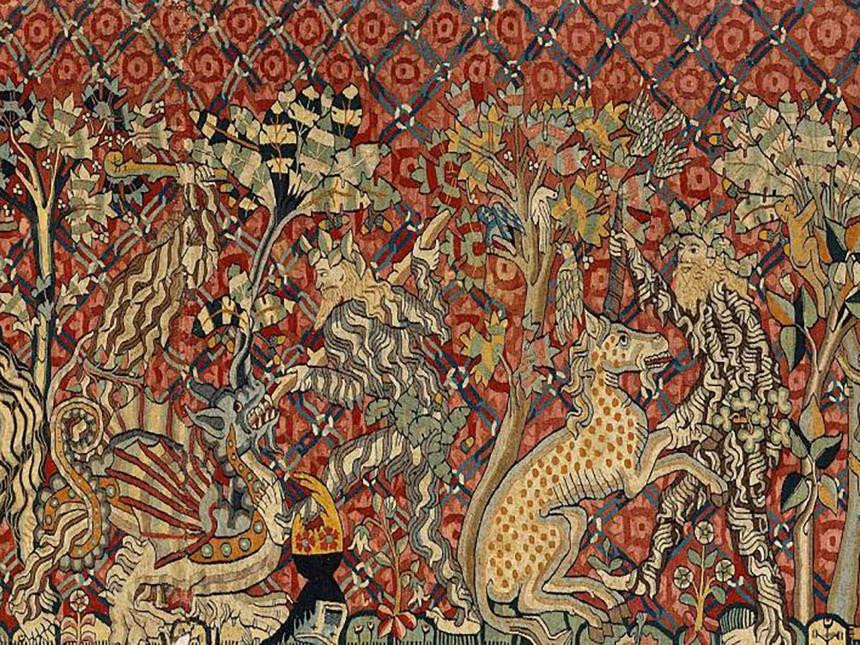 Detail of a medieval tapestry depicting men fighting a dragon and a unicorn, showcasing intricate weaving techniques and vibrant colors.