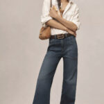 Wide leg jeans outfit idea for fall fashion trends, featuring a stylish woman in wide leg denim and a neutral top.