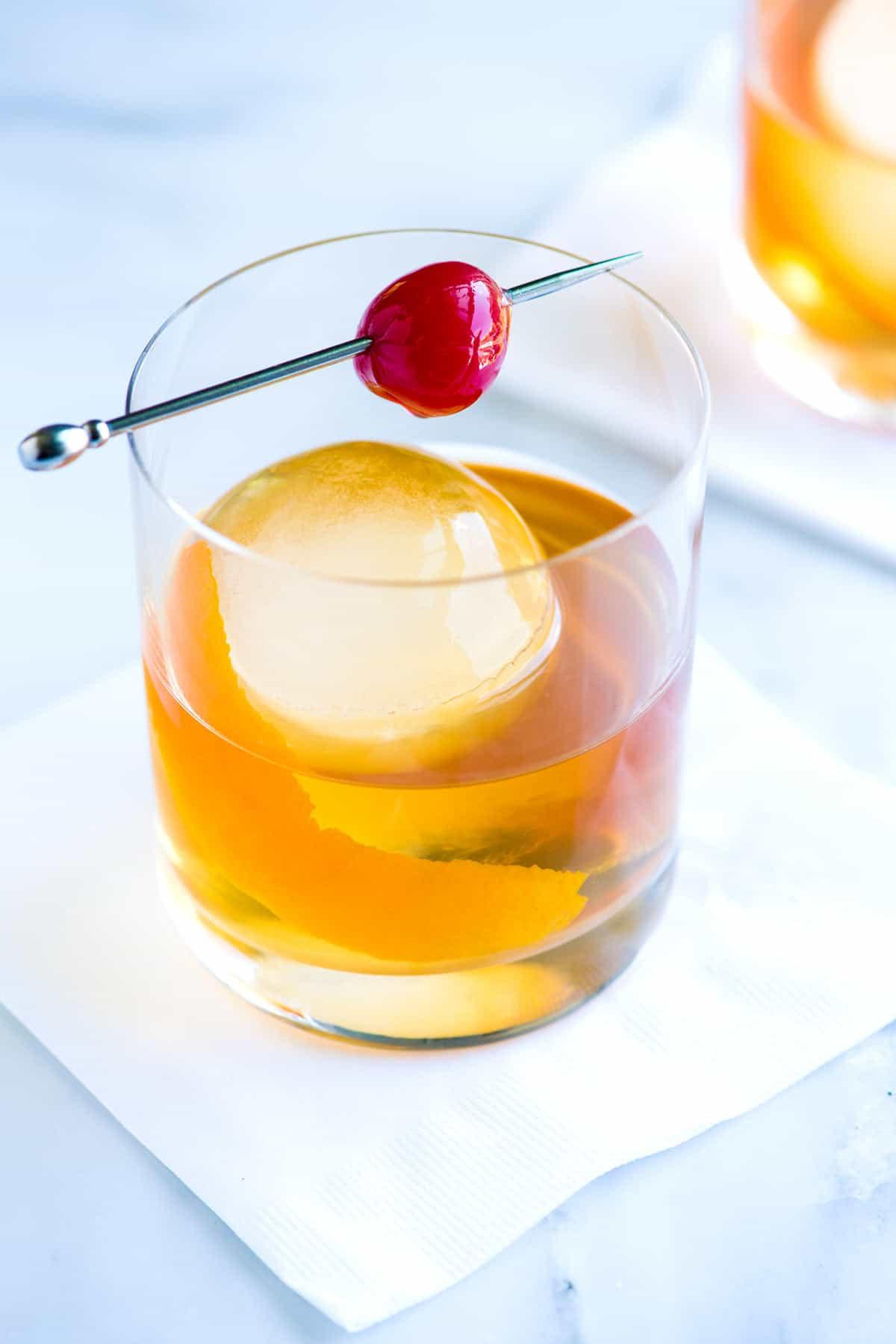 Classic Old Fashioned Cocktail in a rocks glass with an orange peel garnish.