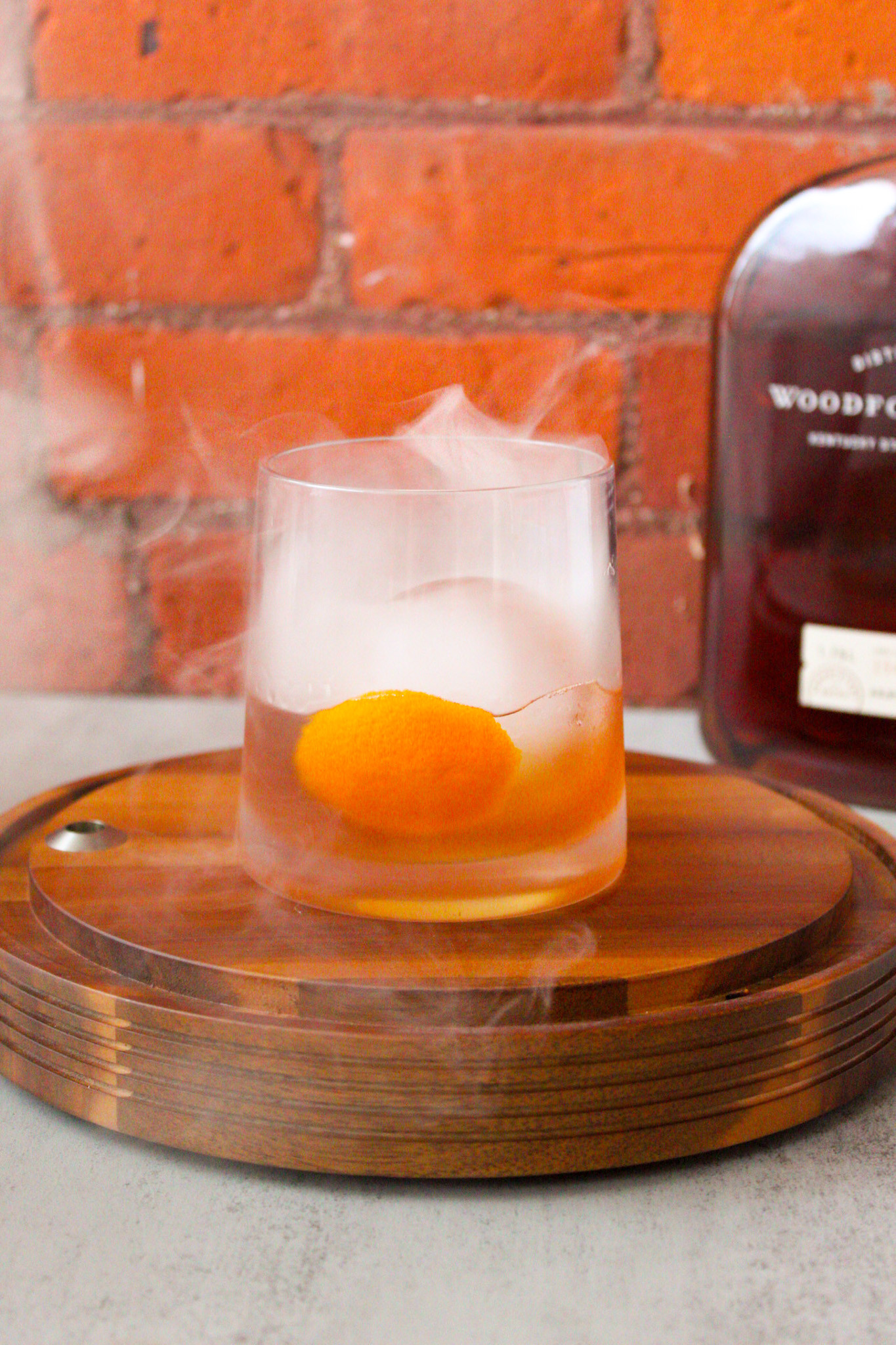 A smoked old fashioned cocktail in a rocks glass.