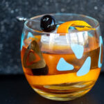 Old Fashioned cocktail in an old fashioned glass garnish with cherry and orange