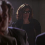 Rene Russo in a fur coat and glasses in The Thomas Crown Affair.