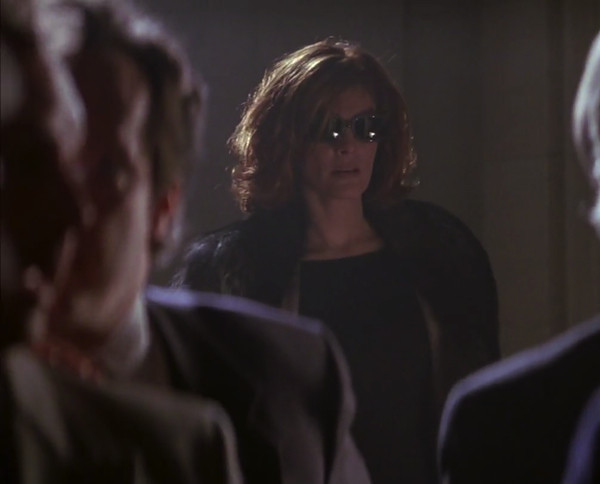 Rene Russo in a fur coat and glasses in The Thomas Crown Affair.