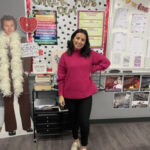 Mrs. Langenwalter in a stylish pink sweater and cream loafers.