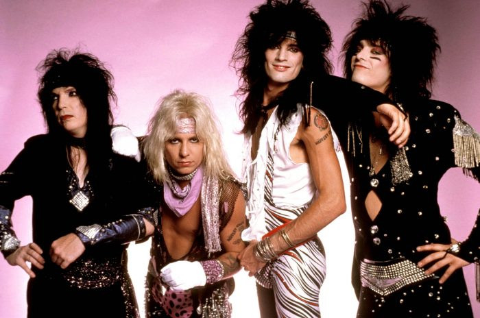 alt: Motley Crue band members posing in quintessential 80s metal fashion with big hair, leather, and makeup.