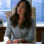 Gina Torres as Jessica Pearson in a sophisticated fashion designer suit, embodying power and elegance in Pearson.