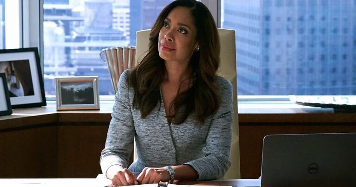 Gina Torres as Jessica Pearson in a sophisticated fashion designer suit, embodying power and elegance in Pearson.