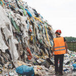 Abandoned fast fashion clothing in a landfill.