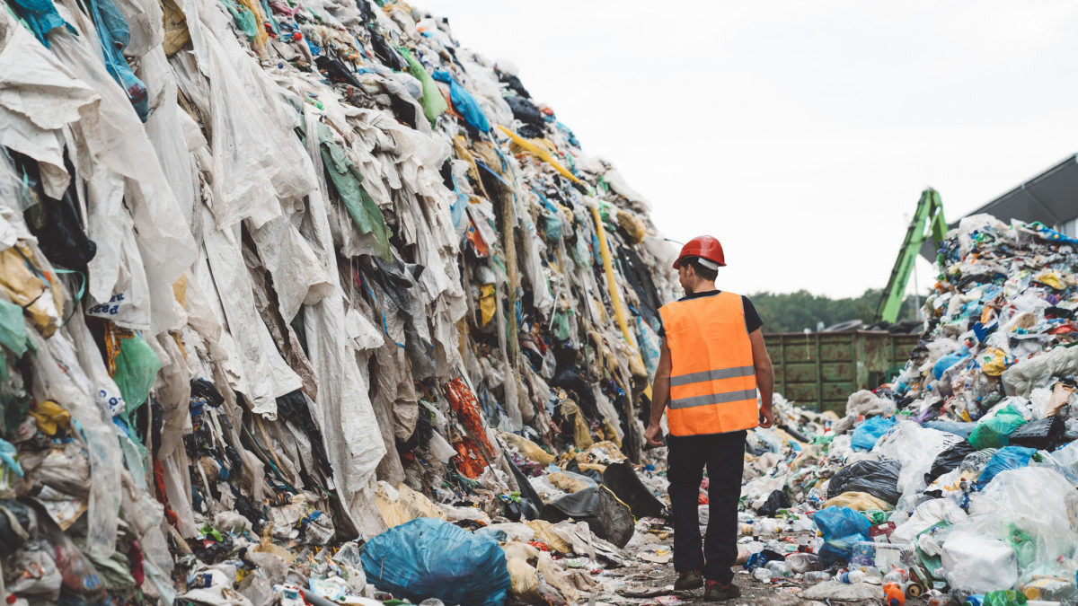 Abandoned fast fashion clothing in a landfill.