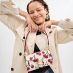 A promotional image for Coach at Del Amo Fashion Center featuring Valentine's Day themed gifts.