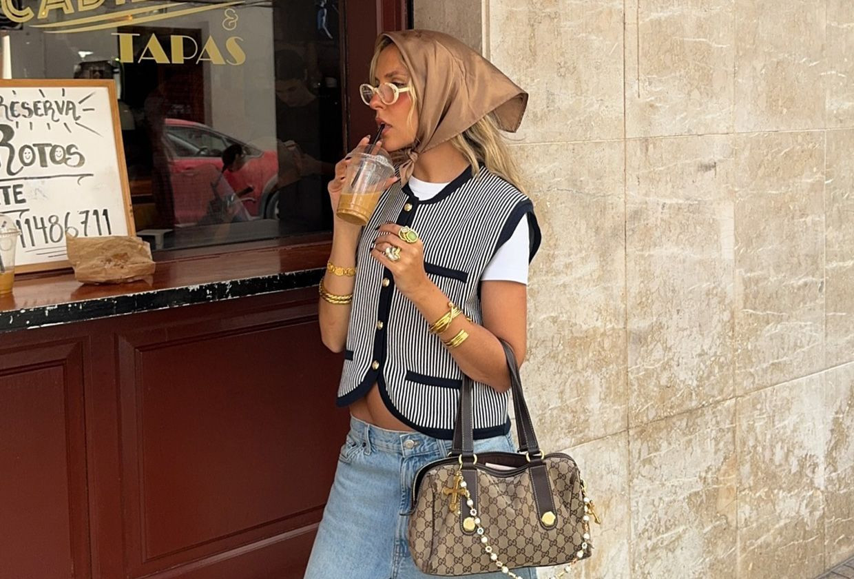 A woman wearing a stylish outfit from ASOS, showcasing a cropped jacket, tank top, leopard print jeans, and beige sneakers.