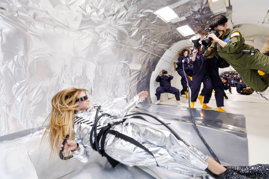 Zero gravity fashion photoshoot preparation with silver foil.