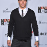 Josh Duhamel in 2007, sporting a metrosexual look with a V-neck sweater over a shirt and tie