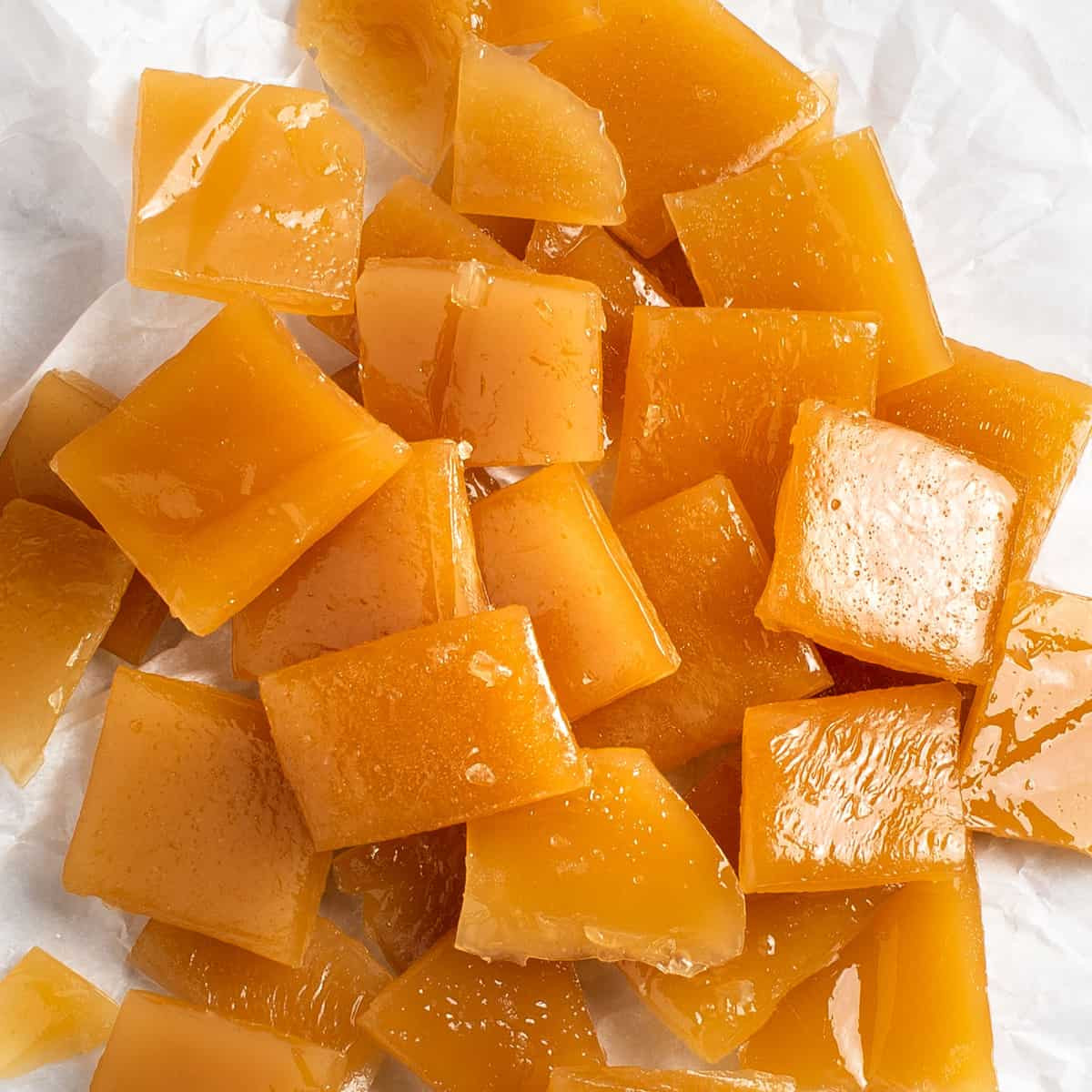 Close up of butterscotch candies in a pile.